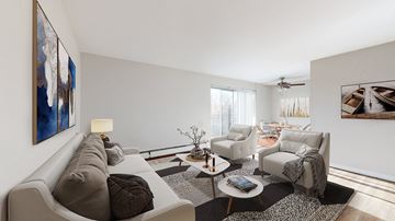 Denver apartment for rent - A living room with a grey couch, a coffee table, and a painting on the wall.