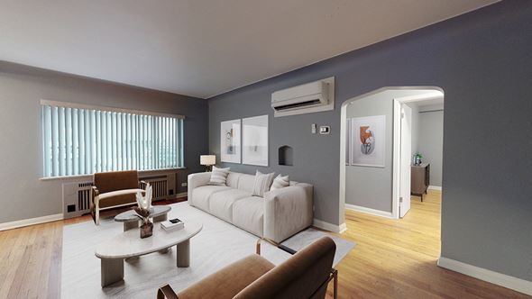 Denver apartment for rent - A living room with a white couch and a brown chair.
