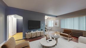 Denver apartment for rent - A living room with a television, two chairs, and a coffee table.