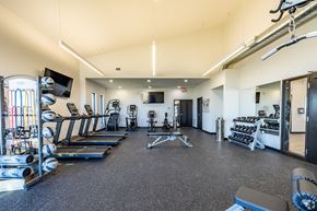 Elkhorn apartment for rent - A spacious gym with treadmills, weights, and exercise equipment.
