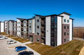 Elkhorn apartment for rent - A row of modern apartment buildings with cars parked in front.