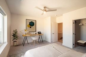 Elkhorn apartment for rent - a bedroom with a bed desk and a ceiling fan
