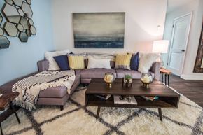 Palm Beach Gardens apartment for rent - A living room with a large sectional sofa, a coffee table, and a rug.
