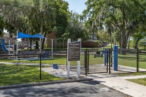 Bradenton apartment for rent - a park with a fence and a sign in front of a playground