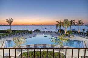 Bradenton apartment for rent - a swimming pool at sunset at the resort at longboat key club