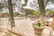 Austin apartment for rent - Wooden deck area with flower planter and picnic tables at Le Montreaux Apartments, Austin, 78759