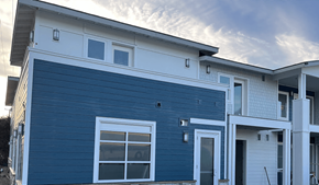 Pismo Beach apartment for rent - a blue house with a cloudy sky in the background