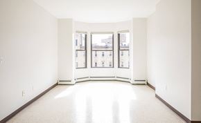 Boston apartment for rent - an empty room with three windows in it