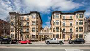 Boston apartment for rent - A row of brown buildings with cars parked in front.