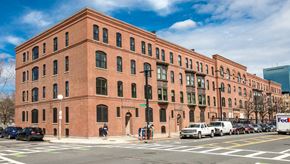 Boston apartment for rent - A red brick building with a white truck parked in front.