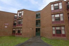 Worcester apartment for rent - A brick building with a green door and windows.