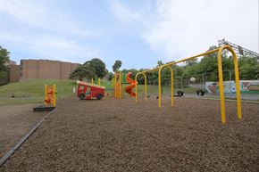 Worcester apartment for rent - A playground with a red and yellow swing set.