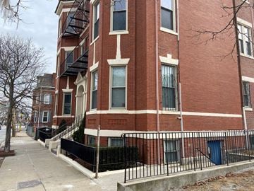 Roxbury apartment for rent - a red brick building with a sidewalk in front of it