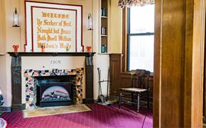 Greenfield apartment for rent - the living room with a fireplace and a poster on the wall