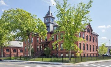 Holyoke apartment for rent - a large red brick building with a clock tower