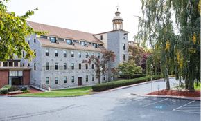 Whitinsville apartment for rent - a building on the side of a street with trees