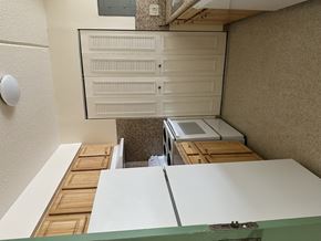 Roxbury apartment for rent - A white cabinet with drawers is mounted on a wall above a wooden table.