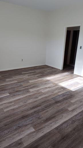 Boston apartment for rent - A room with a wooden floor and a door.