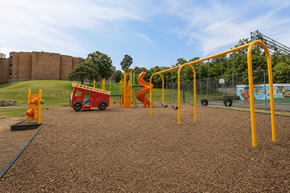 Worcester apartment for rent - A playground with a red and yellow slide and a yellow monkey bars.