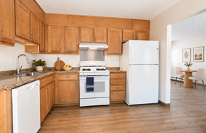 Attleboro apartment for rent - A kitchen with wooden cabinets and a white refrigerator.
