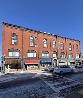 Boston apartment for rent - A red brick building with a white car parked in front of it.