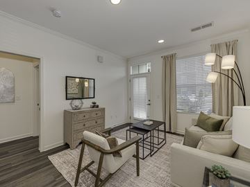 Indian Trail apartment for rent - A living room with a brown chair and a white couch.