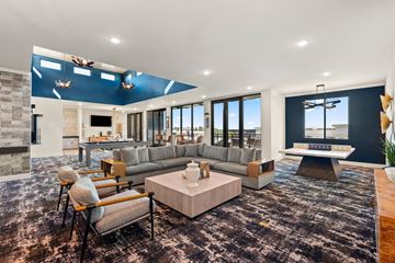 Clayton apartment for rent - A modern living room with a grey sofa and a wooden coffee table.