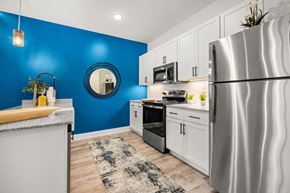 Knoxville apartment for rent - A modern kitchen with a blue wall and stainless steel appliances.