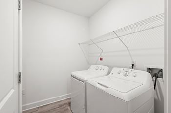 White washing machine and dryer in small laundry room
