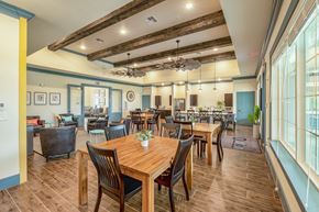 Olmito apartment for rent - a large dining room with wooden tables and chairs
