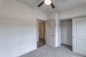 Olmito apartment for rent - an empty bedroom with a ceiling fan and a closet