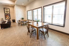 San Antonio apartment for rent - a dining room with a wooden table and chairs and a large window