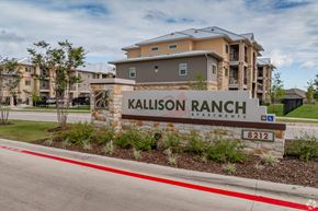 San Antonio apartment for rent - A sign for Kallison Ranch Apartments is in front of a building.