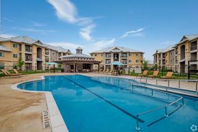 San Antonio apartment for rent - A large swimming pool in front of apartment buildings.
