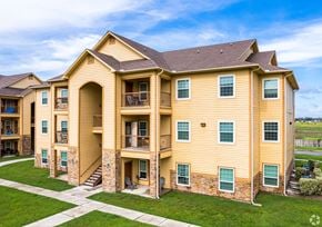 Los Fresnos apartment for rent - A large, two-story apartment building with a mix of balconies and patios.