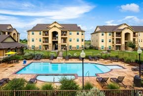 Los Fresnos apartment for rent - A large building with a pool in front of it.