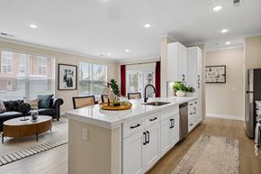 Liberty Township townhouse for rent - A kitchen with white cabinets and a wooden island.