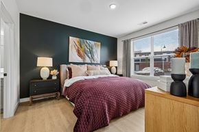 Liberty Township townhouse for rent - A bedroom with a large bed and a painting on the wall.