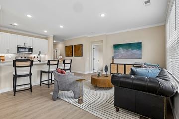 Liberty Township townhouse for rent - A living room with a black leather couch and a grey armchair.
