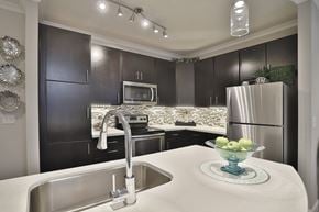 Cincinnati apartment for rent - A modern kitchen with a stainless steel refrigerator and a white countertop.