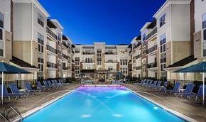 Cincinnati apartment for rent - A swimming pool in a residential area surrounded by lounge chairs and umbrellas.