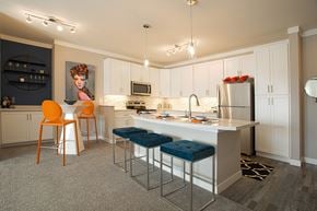 Centerville apartment for rent - A kitchen with a white counter top and blue stools.