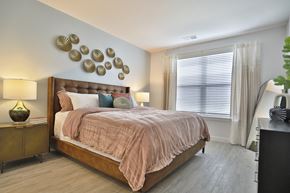 West Chester apartment for rent - a bedroom with a bed and a large window