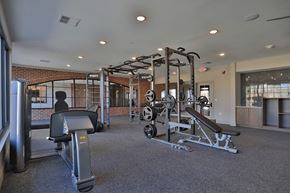 West Chester apartment for rent - A gym with a variety of equipment including a leg press machine.