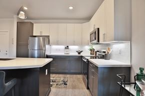 West Chester apartment for rent - A modern kitchen with a refrigerator, microwave, and oven.