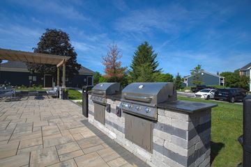 Greenwood apartment for rent - A stone patio with a built-in BBQ grill.