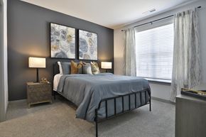 Cincinnati apartment for rent - a bedroom with a bed and a large window