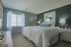 Maineville apartment for rent - A bedroom with a bed, nightstand, and window.