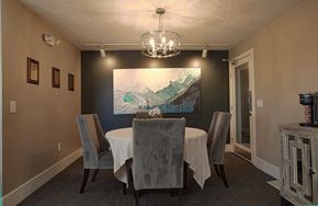 Maineville apartment for rent - A dining room with a table set for two and a painting on the wall.