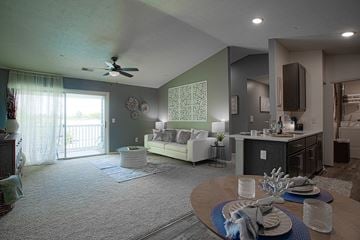 Maineville apartment for rent - A living room with a dining table set for two.